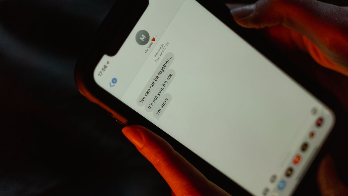 Person checking a possible fake delivery text message on a phone