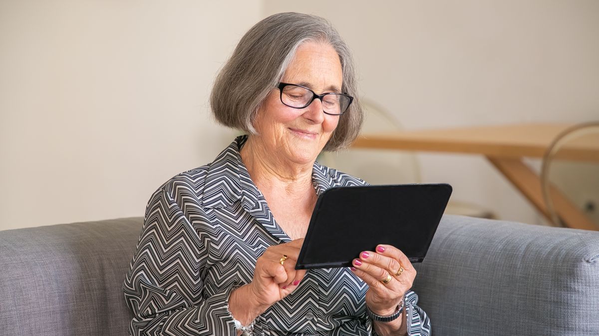Older person learning password safety on a tablet